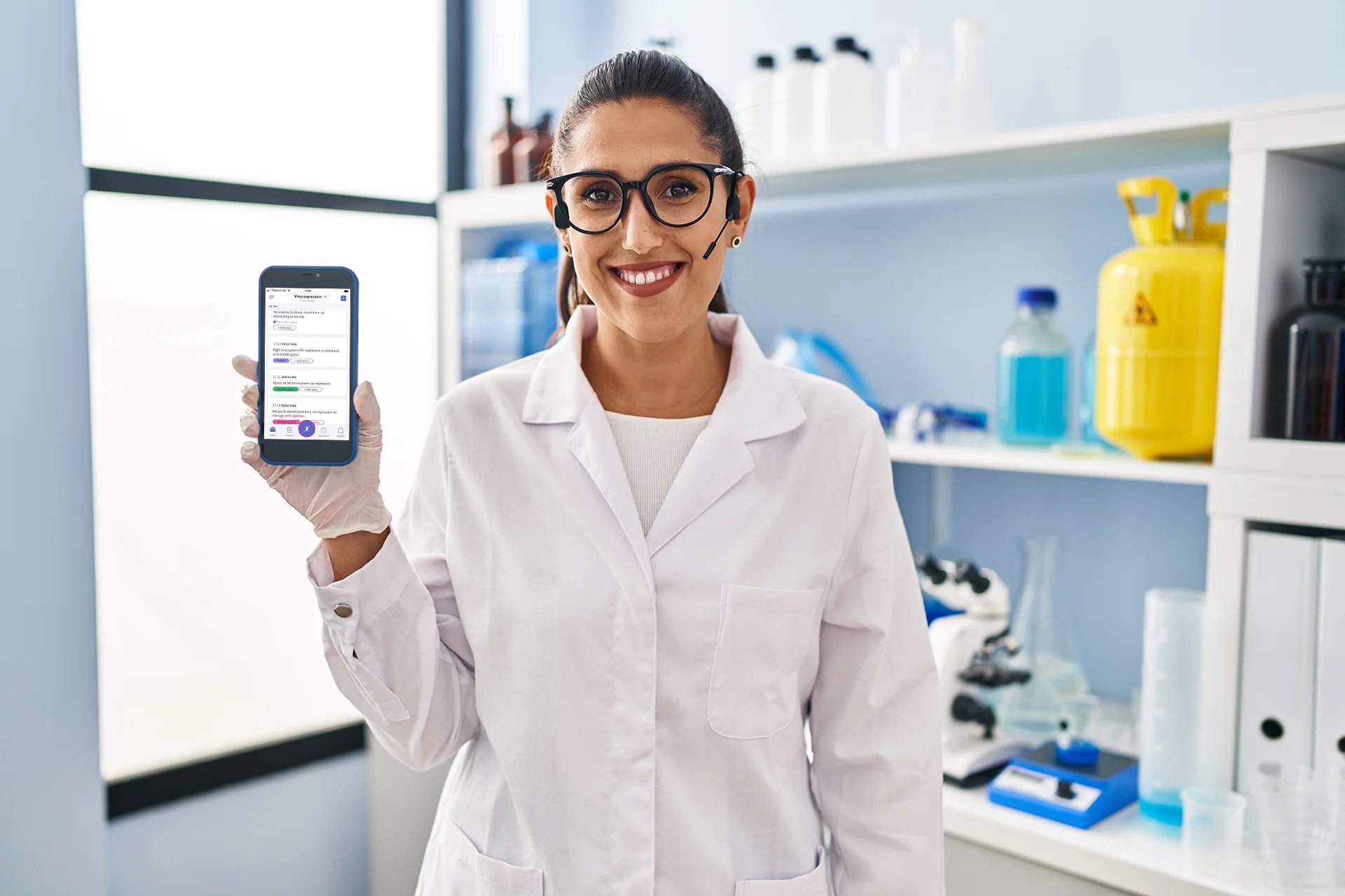 Scientist girl holding phone smiling